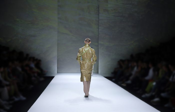 Man Fashion Casual Models walk back Finale on Runway Ramp during Fashion Week to present New Clothing Collection Spring Summer, on empty clean Stage Catwalk with Full Lighting, copy space Image